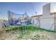 Trampoline in grassy backyard, next to a block-wall fence and detached garage at 4727 N 50Th Dr, Phoenix, AZ 85031