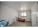 Cozy bedroom with wood floors, white brick walls, and a red twin bed frame with matching blanket at 4727 N 50Th Dr, Phoenix, AZ 85031