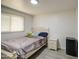 Bedroom with a white bed frame, a window, gray floors, a white nightstand, and white brick walls at 4727 N 50Th Dr, Phoenix, AZ 85031