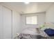 Bedroom with a white bed frame, a window, gray floors, and a white sliding door closet at 4727 N 50Th Dr, Phoenix, AZ 85031