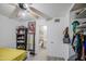 A bedroom featuring a bright window, a ceiling fan, white brick walls, and tile floors at 4727 N 50Th Dr, Phoenix, AZ 85031