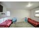 Bright bedroom with brick walls, two beds, tile flooring, and plenty of natural light at 4727 N 50Th Dr, Phoenix, AZ 85031