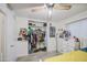 A bedroom featuring a bright window, a ceiling fan, white brick walls, and tile floors at 4727 N 50Th Dr, Phoenix, AZ 85031
