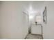 Bright hallway with gray floors, white walls, white storage cabinet and accent picture at 4727 N 50Th Dr, Phoenix, AZ 85031
