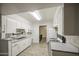 Updated kitchen with stainless steel sink, microwave and ample storage, leading to the dining area at 4727 N 50Th Dr, Phoenix, AZ 85031