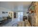The bright living room with a striking stone fireplace, tiled floors, and a sliding glass door at 4727 N 50Th Dr, Phoenix, AZ 85031