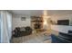 Comfortable living room boasts stone fireplace, tile floors, and neutral color palette at 4727 N 50Th Dr, Phoenix, AZ 85031