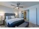 Relaxing bedroom with a ceiling fan, modern decor, and convenient access to laundry at 4901 S Calle Los Cerros Dr # 237, Tempe, AZ 85282