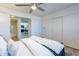 Bright bedroom featuring a ceiling fan, closet, and ensuite bathroom with stylish chevron-patterned tiling at 4901 S Calle Los Cerros Dr # 237, Tempe, AZ 85282