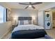 Comfortable bedroom with ceiling fan, lamps, side tables, and convenient access to an in-unit laundry area at 4901 S Calle Los Cerros Dr # 237, Tempe, AZ 85282