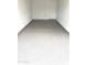 Spacious garage featuring newly epoxied flooring and an interior entry door to the home at 4901 S Calle Los Cerros Dr # 237, Tempe, AZ 85282
