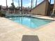 Community pool with palm trees, lounge chairs, and a shaded pergola at 4901 S Calle Los Cerros Dr # 237, Tempe, AZ 85282