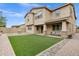 Large backyard with an artificial grass lawn, BBQ, and paver patio providing ample space at 5223 S Axiom --, Mesa, AZ 85212