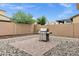 Backyard featuring gravel, pavers, a built-in BBQ grill, a privacy wall, and a shade tree at 5223 S Axiom --, Mesa, AZ 85212