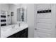 Bathroom featuring a modern sink with a black cabinet, complemented by a towel hook and a shower at 5223 S Axiom --, Mesa, AZ 85212
