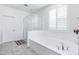 Clean, white bathroom with soaking tub and glass-enclosed shower providing a modern feel at 5223 S Axiom --, Mesa, AZ 85212
