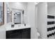 Bathroom featuring a sink with black cabinets, a mirror and a shower with a striped curtain, very modern at 5223 S Axiom --, Mesa, AZ 85212