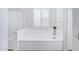 Bright bathroom featuring a soaking tub, white cabinets, and a window with stylish shutters at 5223 S Axiom --, Mesa, AZ 85212