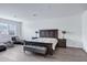 Bedroom featuring a king bed, two nightstands, hardwood style floors and natural light from shuttered windows at 5223 S Axiom --, Mesa, AZ 85212