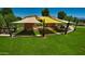 Community park featuring a staged area covered with yellow and tan shade sails at 5223 S Axiom --, Mesa, AZ 85212