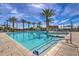 Large community pool with plenty of chairs and palm trees with bright sunny skies at 5223 S Axiom --, Mesa, AZ 85212