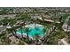 An aerial view showcases a community pool surrounded by palm trees and inviting lounge chairs at 5223 S Axiom --, Mesa, AZ 85212