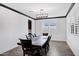 Formal dining room with wood floors, modern lighting, and large window with wood shutters at 5223 S Axiom --, Mesa, AZ 85212