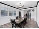 Elegant dining room featuring a dark wood table with seating for six, stylish light fixtures, and stairs at 5223 S Axiom --, Mesa, AZ 85212