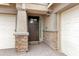Inviting front entryway with a dark wood door, stone accents, and a charming lantern fixture at 5223 S Axiom --, Mesa, AZ 85212