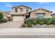 Charming two-story home featuring a three-car garage, beautiful landscaping, and a welcoming facade at 5223 S Axiom --, Mesa, AZ 85212