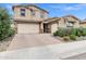 Beautiful two-story home with a brick driveway, three-car garage, and well-maintained landscaping at 5223 S Axiom --, Mesa, AZ 85212