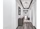 Elegant hallway features hardwood floors, wainscotting, stylish light fixtures, and tasteful decor at 5223 S Axiom --, Mesa, AZ 85212