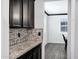 View of the kitchen counter featuring granite countertops and mosaic tile backsplash at 5223 S Axiom --, Mesa, AZ 85212