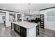 Open kitchen with a large island, microwave, and seamless flow to living area at 5223 S Axiom --, Mesa, AZ 85212