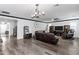 Spacious living room featuring hardwood floors and an eye-catching light fixture at 5223 S Axiom --, Mesa, AZ 85212