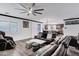 Open-concept living room featuring leather couches, ceiling fan, and kitchen view at 5223 S Axiom --, Mesa, AZ 85212
