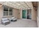 Relaxing covered patio with comfortable seating, a ceiling fan, and views of the backyard at 5223 S Axiom --, Mesa, AZ 85212