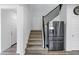 Staircase and stainless steel refrigerator on the main floor of the home at 5223 S Axiom --, Mesa, AZ 85212