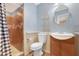 Bathroom featuring a tiled shower, vanity with sink, and toilet at 612 N Recker Rd, Mesa, AZ 85205