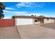 Single-story home with a two-car garage and low-maintenance desert landscaping at 612 N Recker Rd, Mesa, AZ 85205