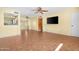 Bright living room with tile floors, ceiling fans, and a pass-through to the kitchen at 612 N Recker Rd, Mesa, AZ 85205