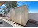 Exterior view of storage shed with siding and a standard door at 612 N Recker Rd, Mesa, AZ 85205