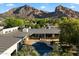 Aerial view of the home highlighting the pool, deck, and breathtaking mountain backdrop at 6417 N 52Nd Pl, Paradise Valley, AZ 85253