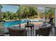 Charming backyard pool with swan floats, surrounded by lush greenery and comfortable seating at 6417 N 52Nd Pl, Paradise Valley, AZ 85253