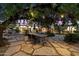 The backyard includes a stone patio with table and chairs, and a view of the pool at dusk at 6417 N 52Nd Pl, Paradise Valley, AZ 85253