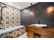 Modern bathroom featuring custom tiled walls around a tub, wooden cabinets, a pendant light and contemporary fixtures at 6417 N 52Nd Pl, Paradise Valley, AZ 85253