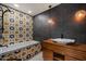 Bathroom with decorative accent wall, bathtub with custom tiling, and modern wood vanity at 6417 N 52Nd Pl, Paradise Valley, AZ 85253