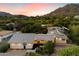 Captivating twilight exterior elevation of a modern home, with desert landscaping and mountain backdrop at 6417 N 52Nd Pl, Paradise Valley, AZ 85253