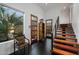 Bright foyer with a staircase, tile floors, and wood doors leading to outdoor spaces at 6417 N 52Nd Pl, Paradise Valley, AZ 85253