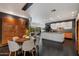 Open-concept kitchen and dining area with modern lighting, sleek cabinets, and backyard views at 6417 N 52Nd Pl, Paradise Valley, AZ 85253